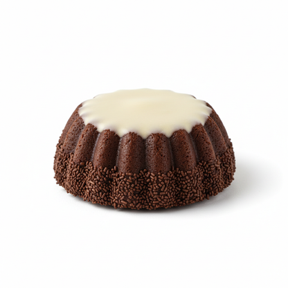 Malted chocolate petite cookie with curved fluted sides, ivory glaze and cocoa sprinkles on edges